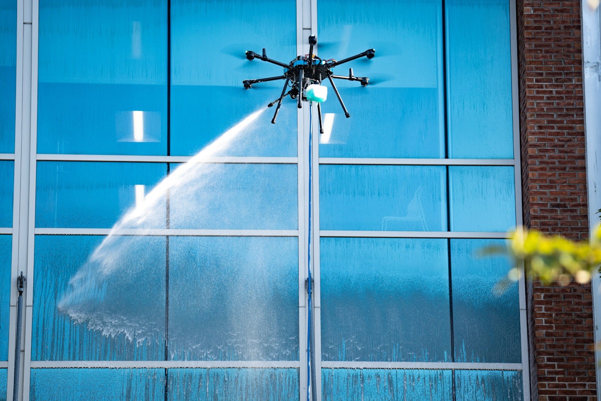 Sherpa drone cleaning the upper windows of a multi-story property