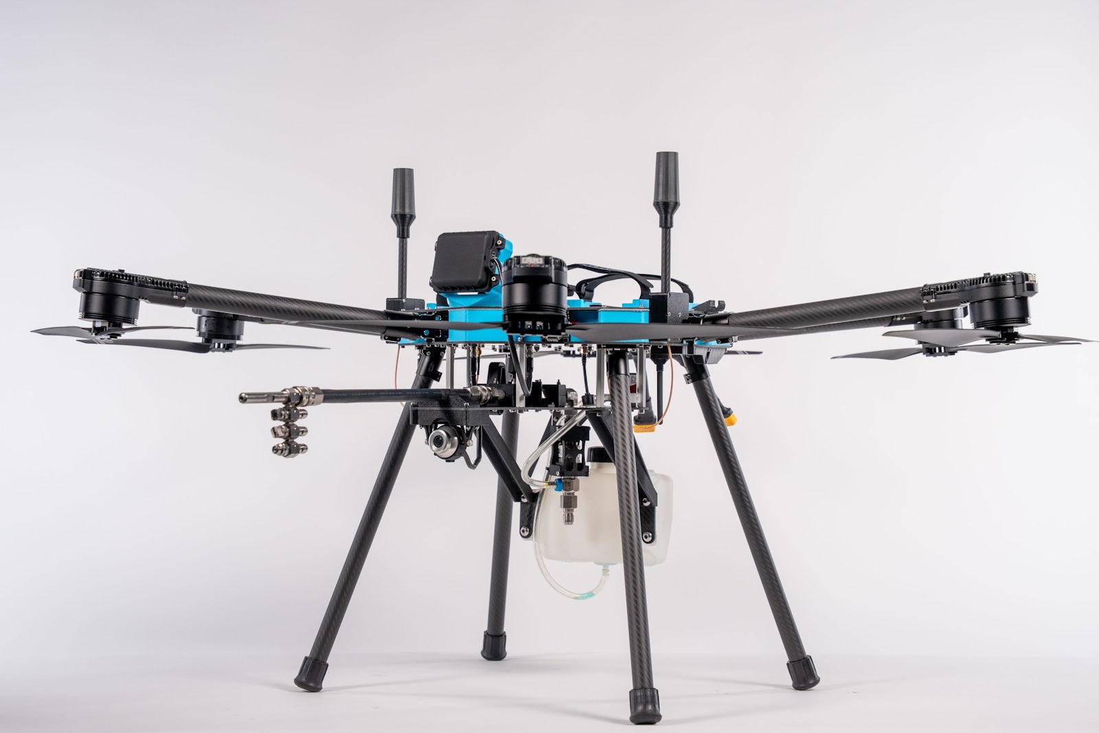 The Lucid Bots Sherpa cleaning drone with its blue and black airframe and spray system